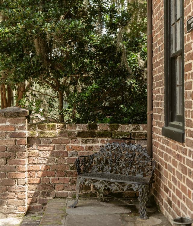 iron bench against historic brick building